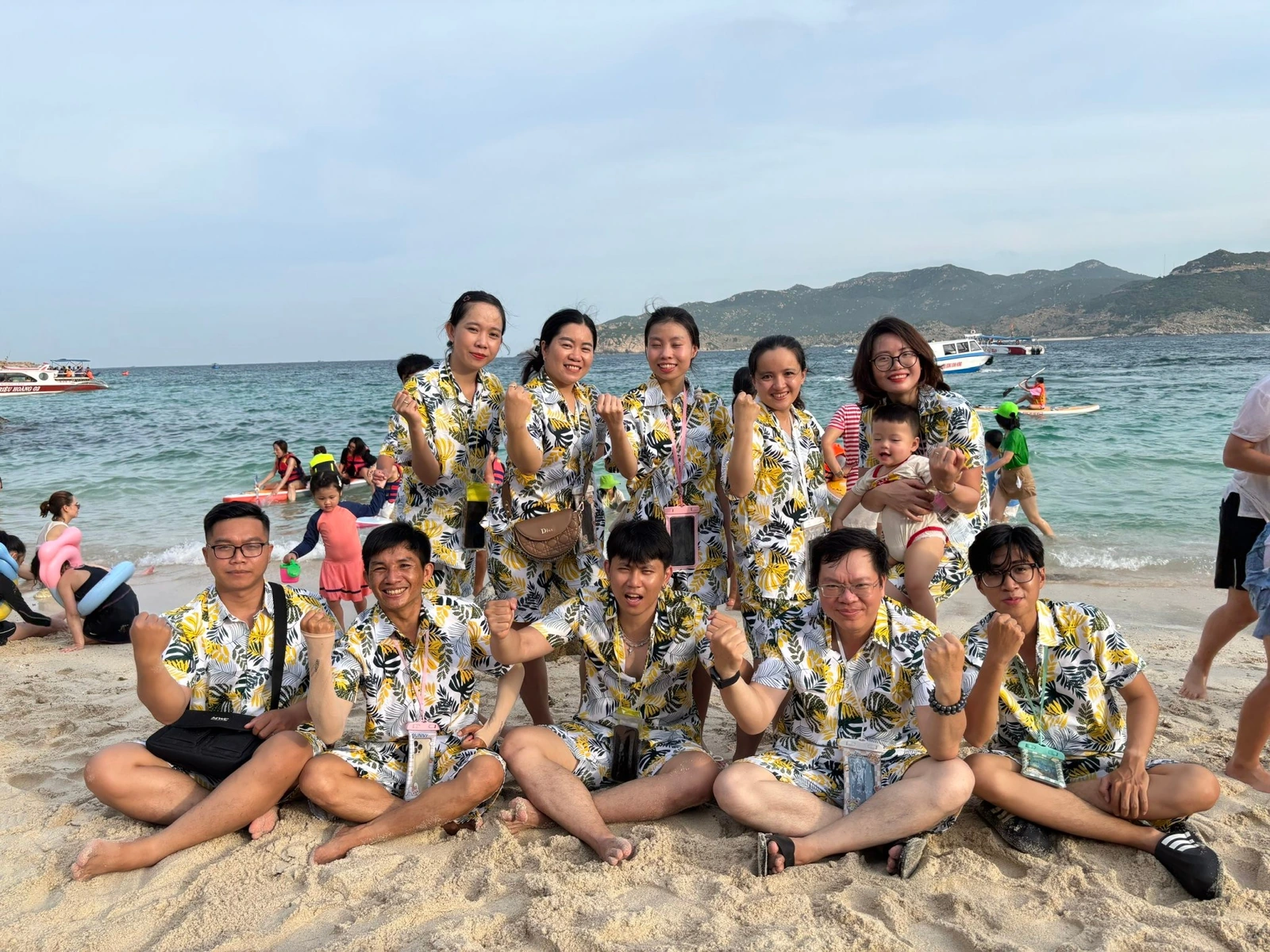 Team members and families at the seaside